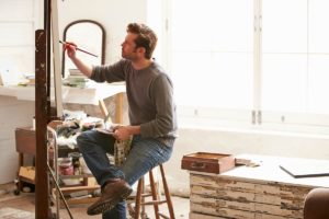 a man paints as a hobby to improve his mental health