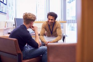 a young man explores the options of cbt and dbt with an addiction treatment specialist to figure out which approach is best for him and his recovery